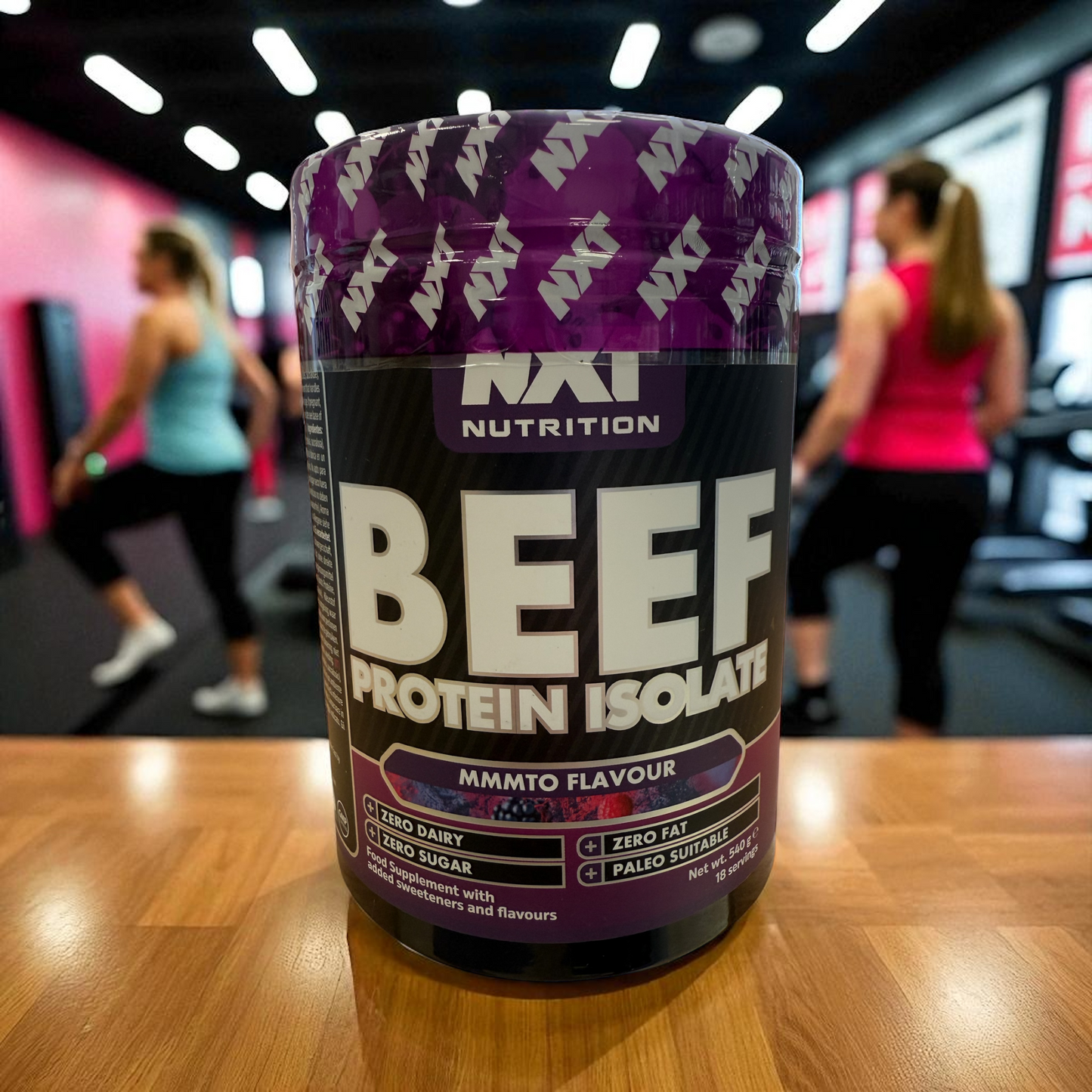 Beef protein isolate container on a wooden surface with people in the background