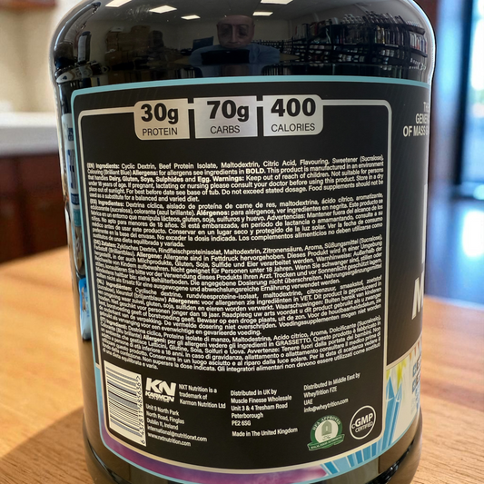 Back label of a supplement container with nutritional information and branding on a wooden surface.