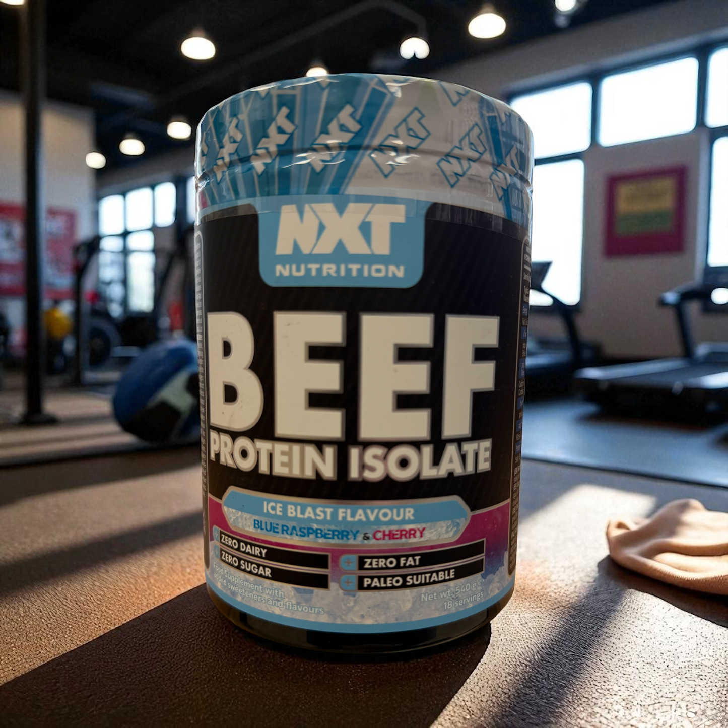 NXT Nutrition Beef Protein Isolate container in a gym setting ice blast flavour