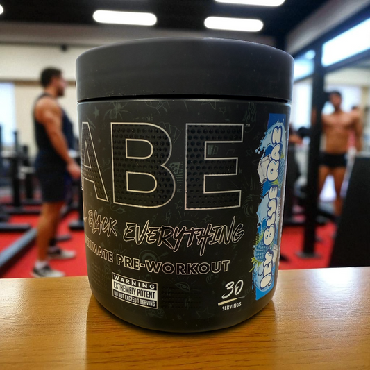 ABE Black Everything pre-workout supplement container on a table in a gym setting in Blue Raz flavour