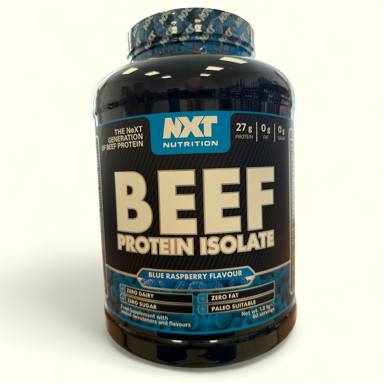 Beef protein isolate container with NXT Nutrition branding on a white background in blue raspberry flavour