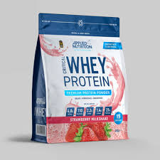 Package of whey protein powder with strawberry flavor on a gray background