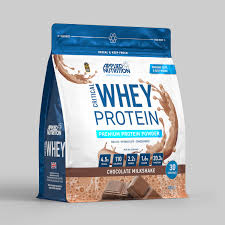 Whey protein powder package with blue and white design on a gray background