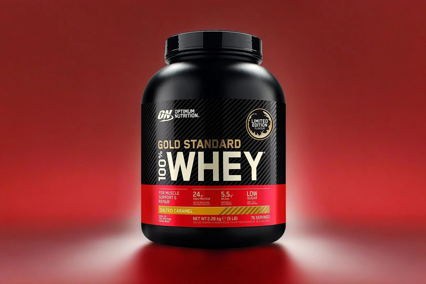 Optimum Nutrition Gold Standard 100% Whey protein powder container on a red background